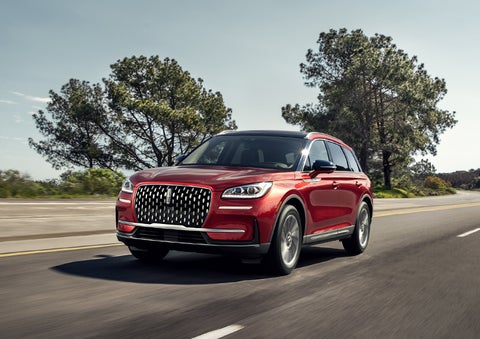 A 2023 Lincoln Corsair® SUV is shown being driven on a country road. | Doggett Lincoln of Beaumont in Beaumont TX