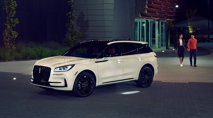 Two people approach a 2024 Lincoln Corsair® SUV featuring the available Jet Appearance Package. | Doggett Lincoln of Beaumont in Beaumont TX