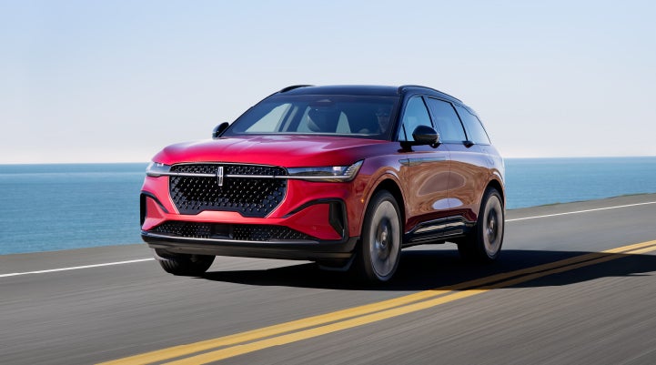 A 2024 Lincoln Nautilus® SUV is being driven on a seaside roadway. | Doggett Lincoln of Beaumont in Beaumont TX