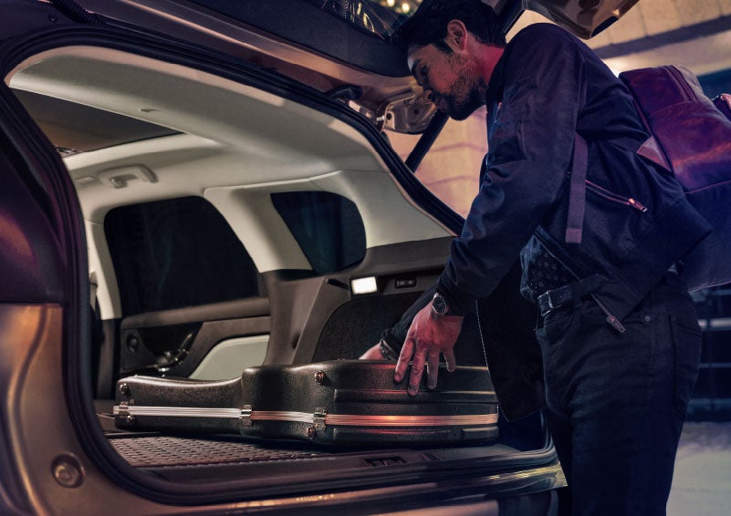 A man is shown loading cargo into the rear of a 2024 Lincoln Corsair® SUV with the second-row seats folded flat. | Doggett Lincoln of Beaumont in Beaumont TX
