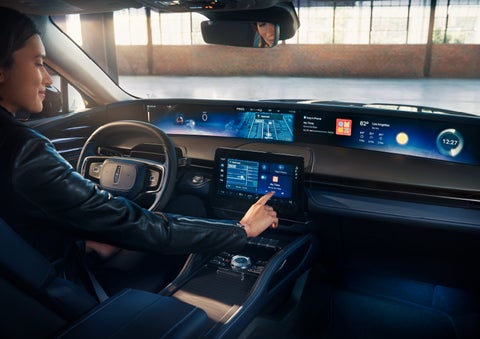 The driver of a 2025 Lincoln Nautilus® SUV interacts with the center touchscreen. | Doggett Lincoln of Beaumont in Beaumont TX