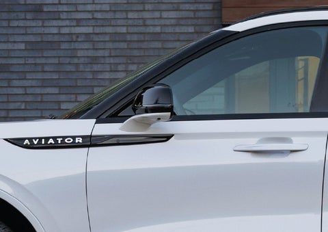 The driver’s side door and fender badging of a white 2026 Lincoln Aviator® SUV are showcased. | Doggett Lincoln of Beaumont in Beaumont TX