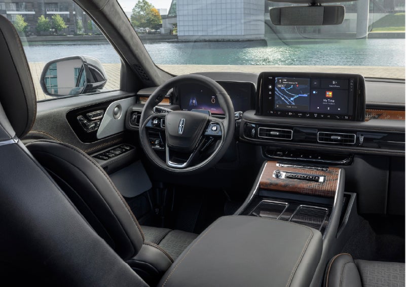 The interior of the 2026 Lincoln Aviator® SUV is shown parked with a view of a harbor through the windshield. | Doggett Lincoln of Beaumont in Beaumont TX