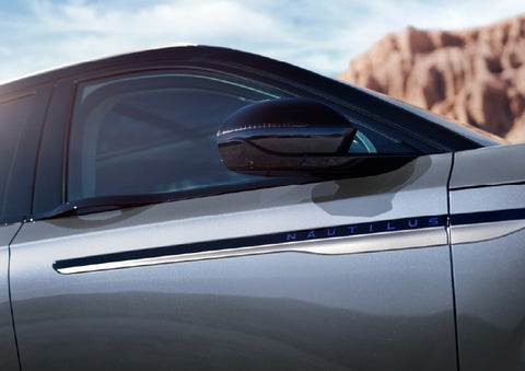 Blue lettering on the side of the vehicle that reads Nautilus indicates the available Hybrid Powertrain. | Doggett Lincoln of Beaumont in Beaumont TX