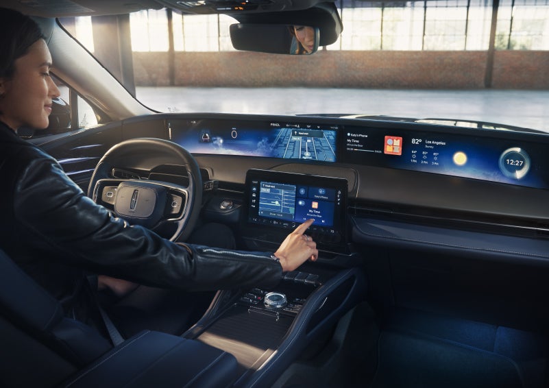 The driver of a 2026 Lincoln Nautilus® SUV interacts with the center touchscreen. | Doggett Lincoln of Beaumont in Beaumont TX