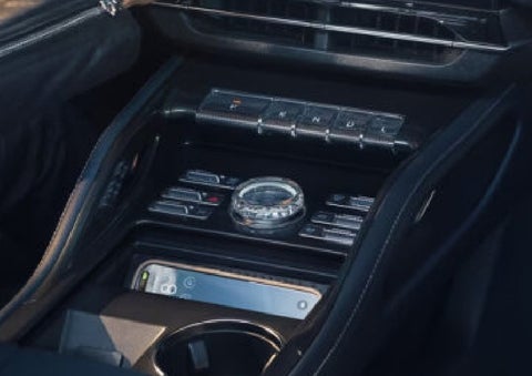 A smartphone is shown charging in the wireless charging pad. | Doggett Lincoln of Beaumont in Beaumont TX